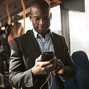criminal justice professional looking at phone while riding public transportation