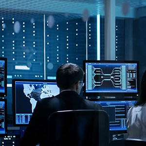 intelligence studies professional looking at global map on computer screen