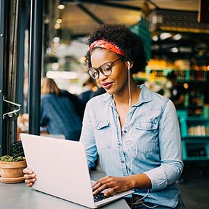 psychology student in cafe working on laptop